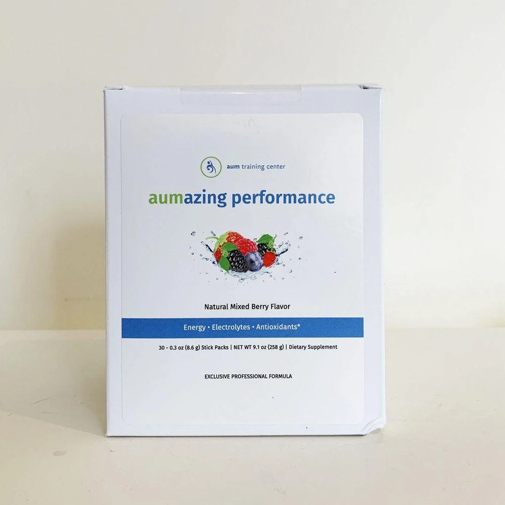 A white box labeled "aumazing performance" with images of mixed berries, detailing natural mixed berry flavor and supplement information on the front.
