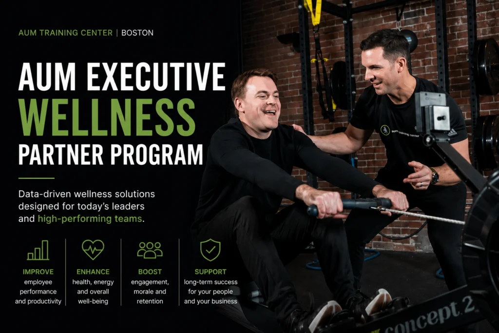 9D9B6331-423B-4EBA-9989-186B8A9231F5 Two men exercise together in a gym. The left side of the image features text promoting the AUM Executive Wellness Partner Program and its benefits for leaders and teams, highlighting why Boston professionals are turning to this comprehensive executive wellness partner for optimal performance.
